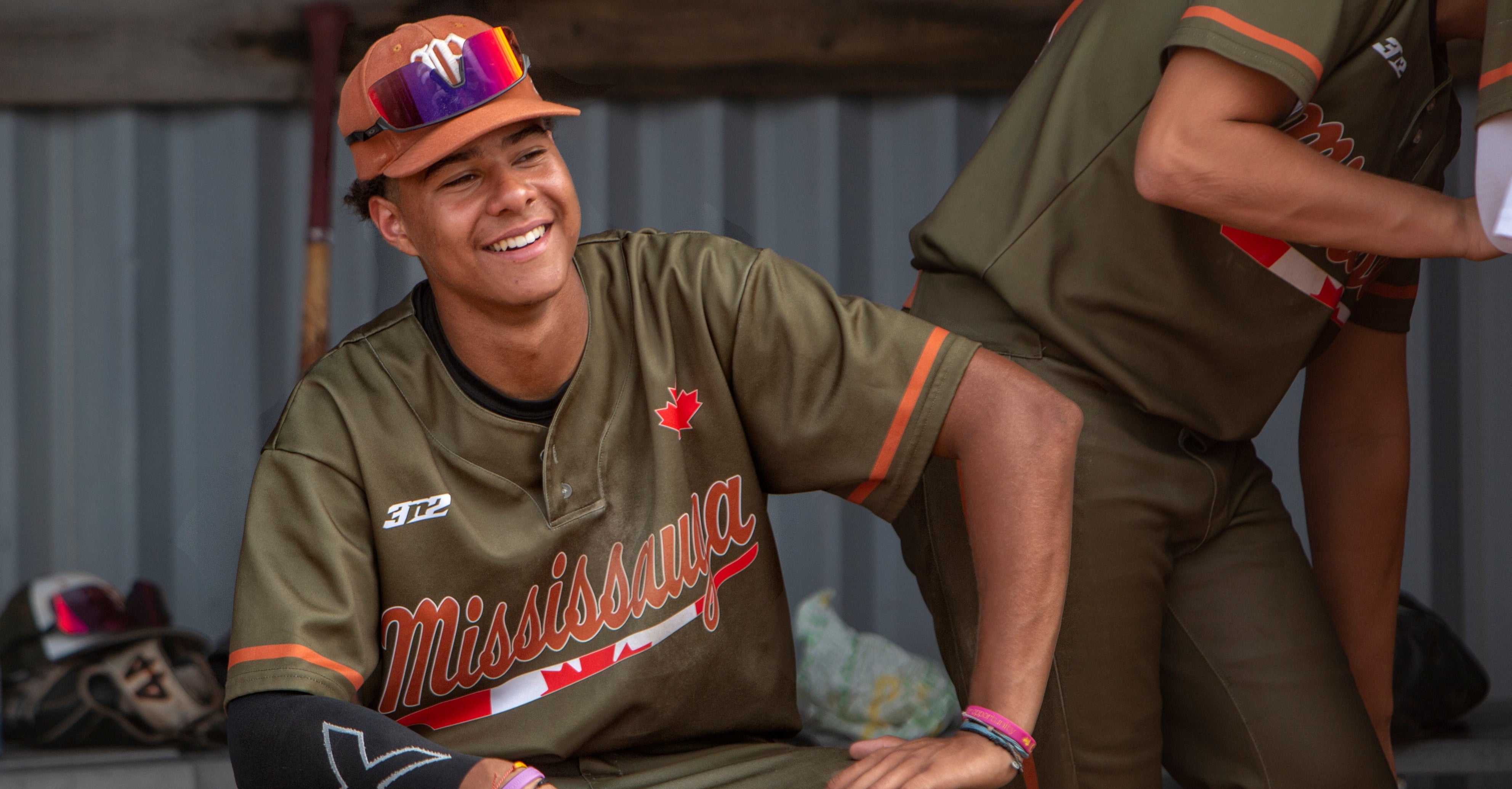 Athlete smiling wearing army green 3N2 baseball uniform, 3N2 news and stories page